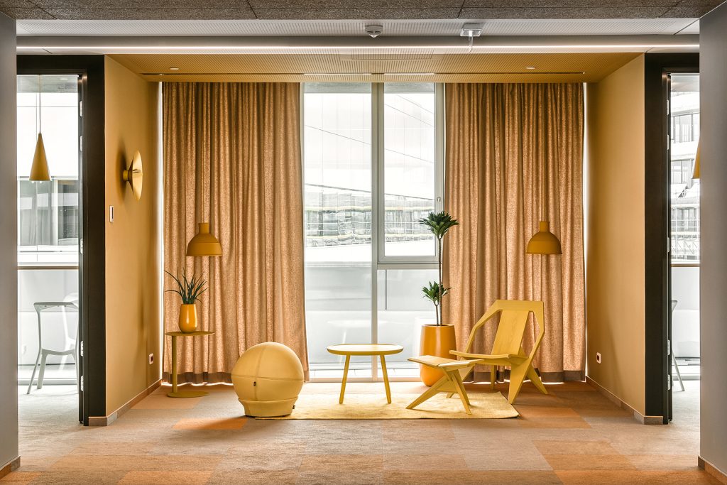 yellow themed workspace interior supporting creative collaboration Nordeus office
